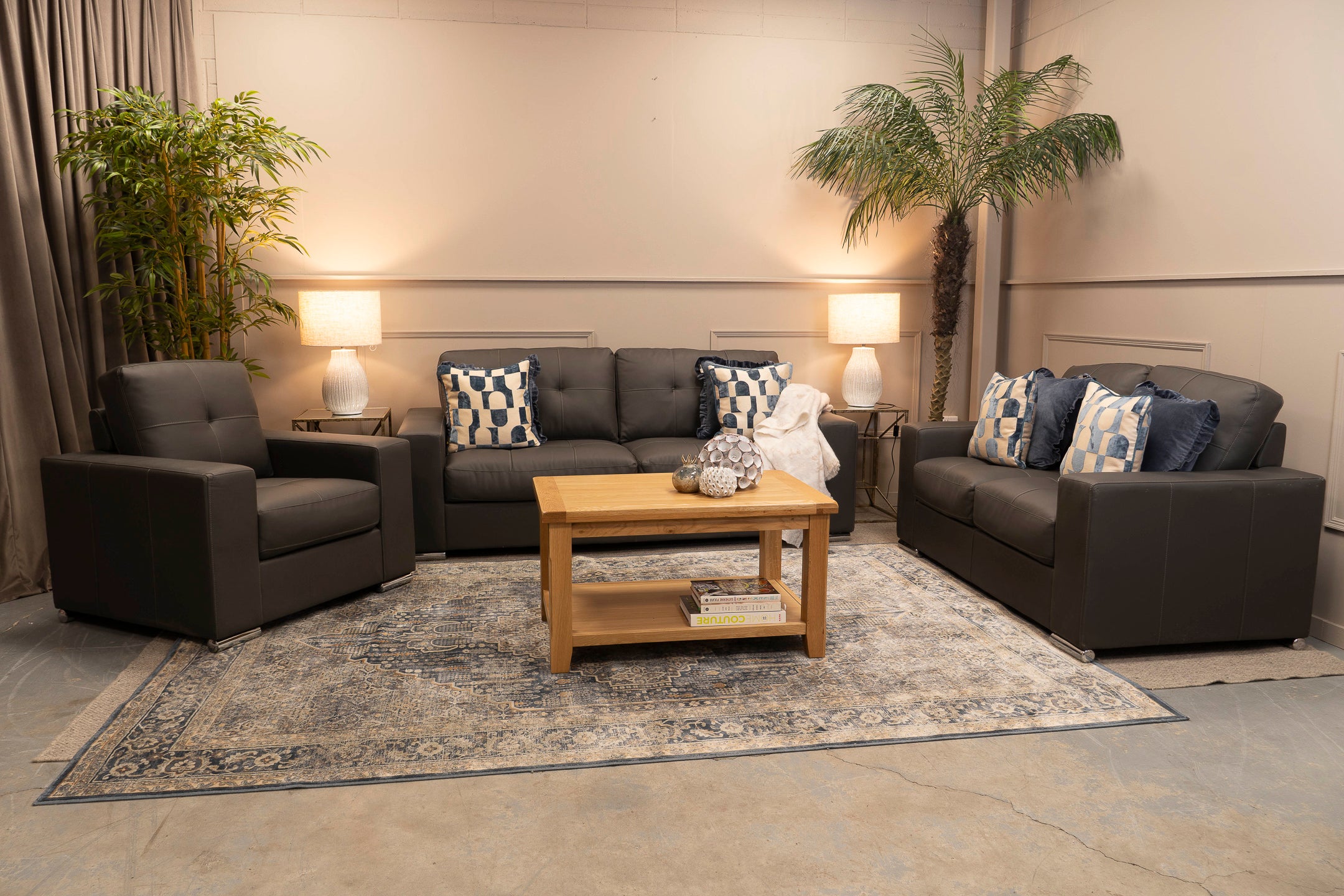 Living room with dark gray sofa, armchair, and wooden coffee table.
